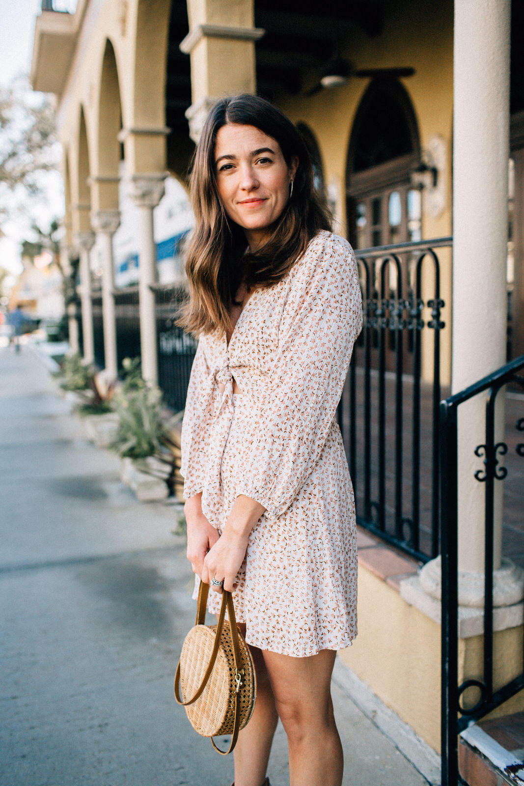 brunette fashion blogger wearing vacation date night outfit in naples florida faithfull the brand trinidad floral print dress serpui marie wicker handbag