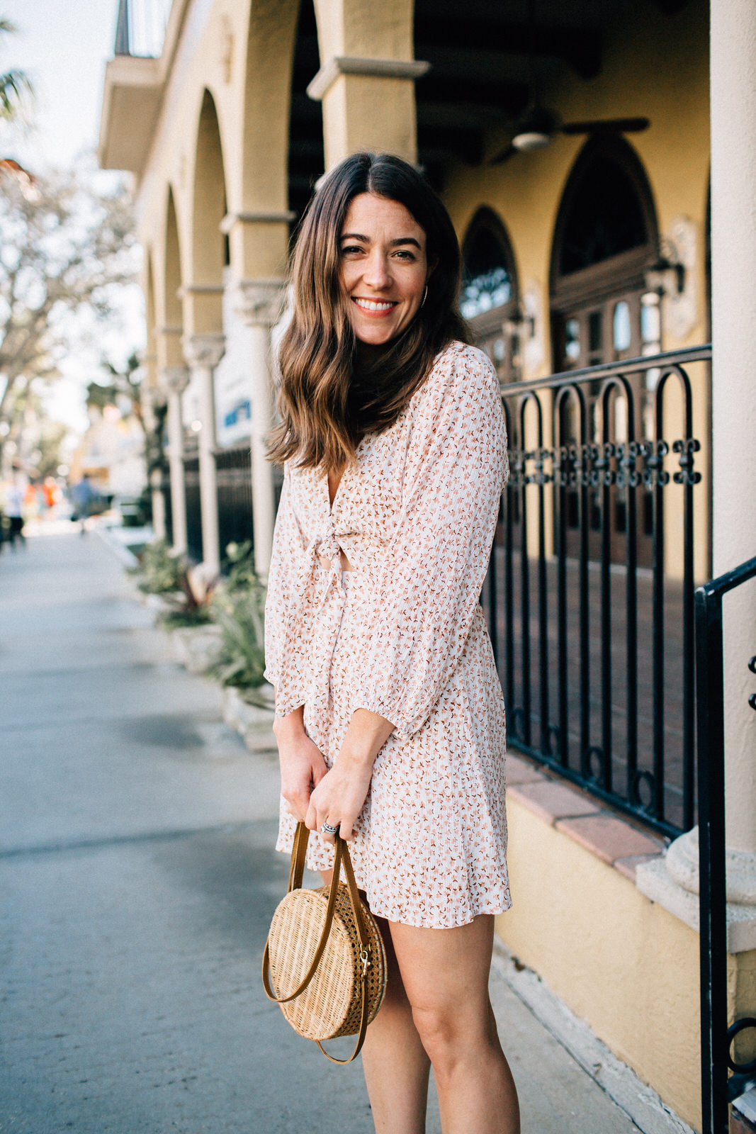 vacation date night outfit in naples florida wearing faithfull the brand trinidad floral print dress serpui marie wicker handbag